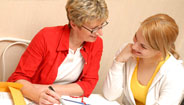 Two women reviewing papers