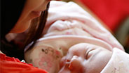 Mother holding sleeping baby